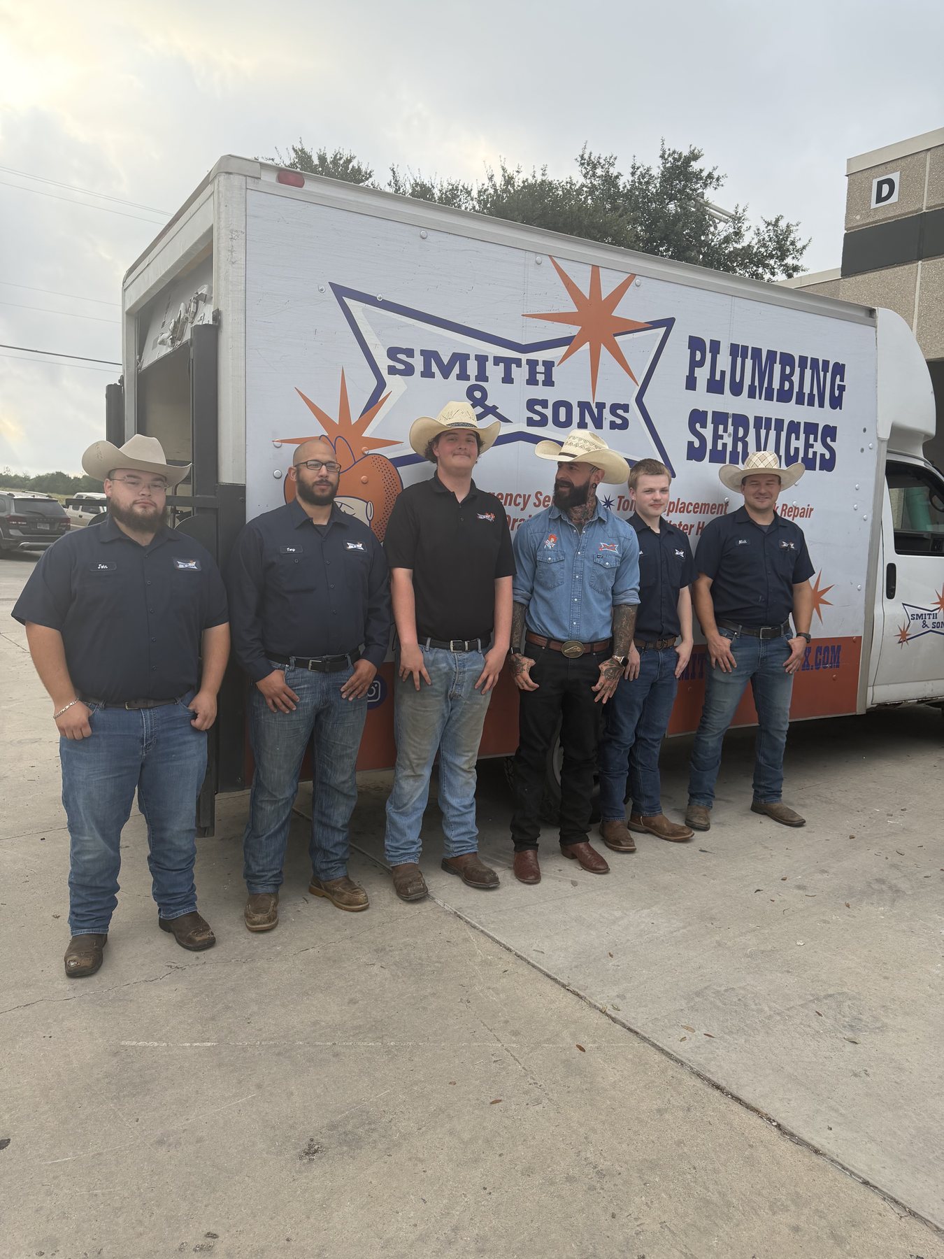 Current Smith & Sons Plumbing team in front of a service truck